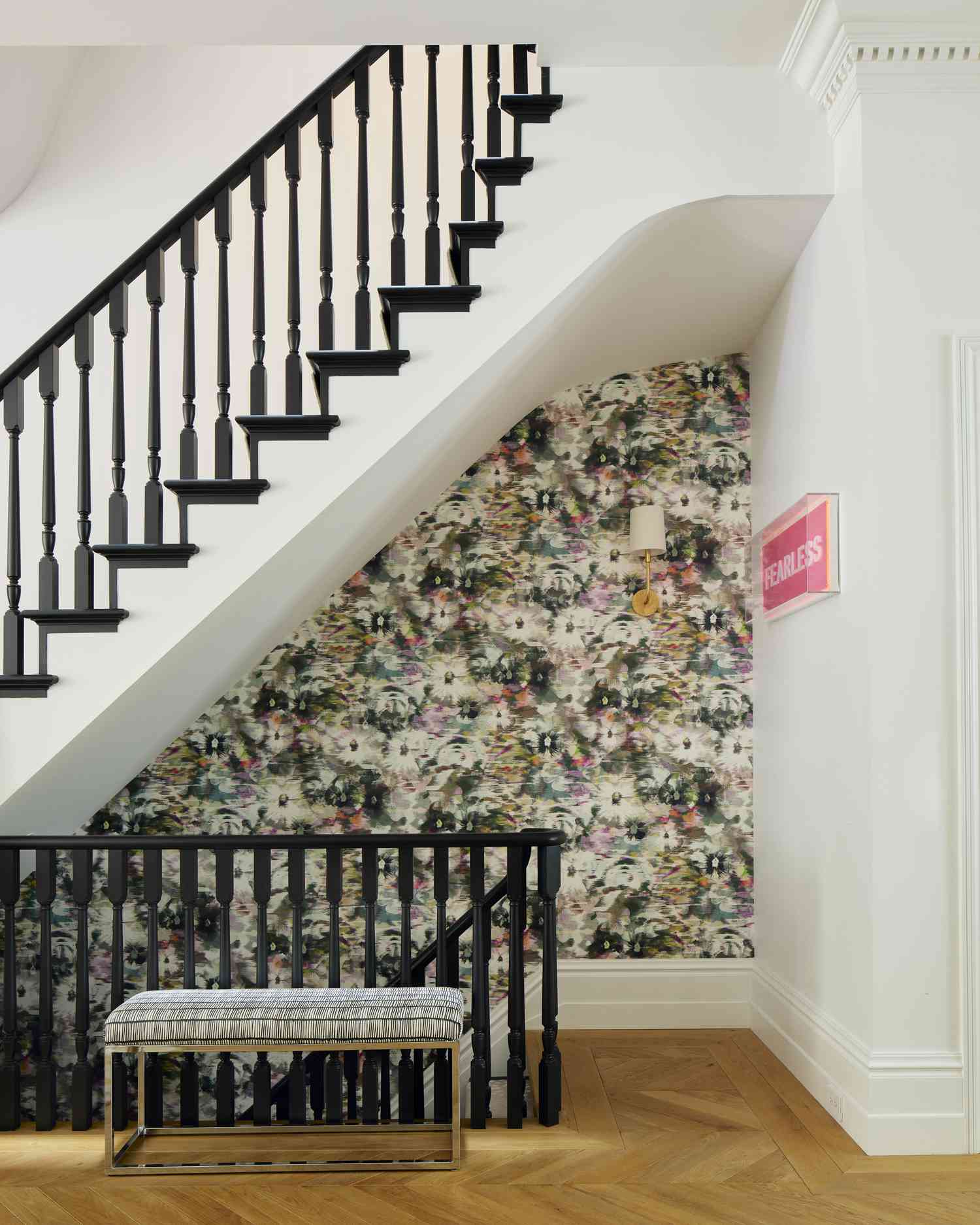 black wooden staircase with patterned wallpaper