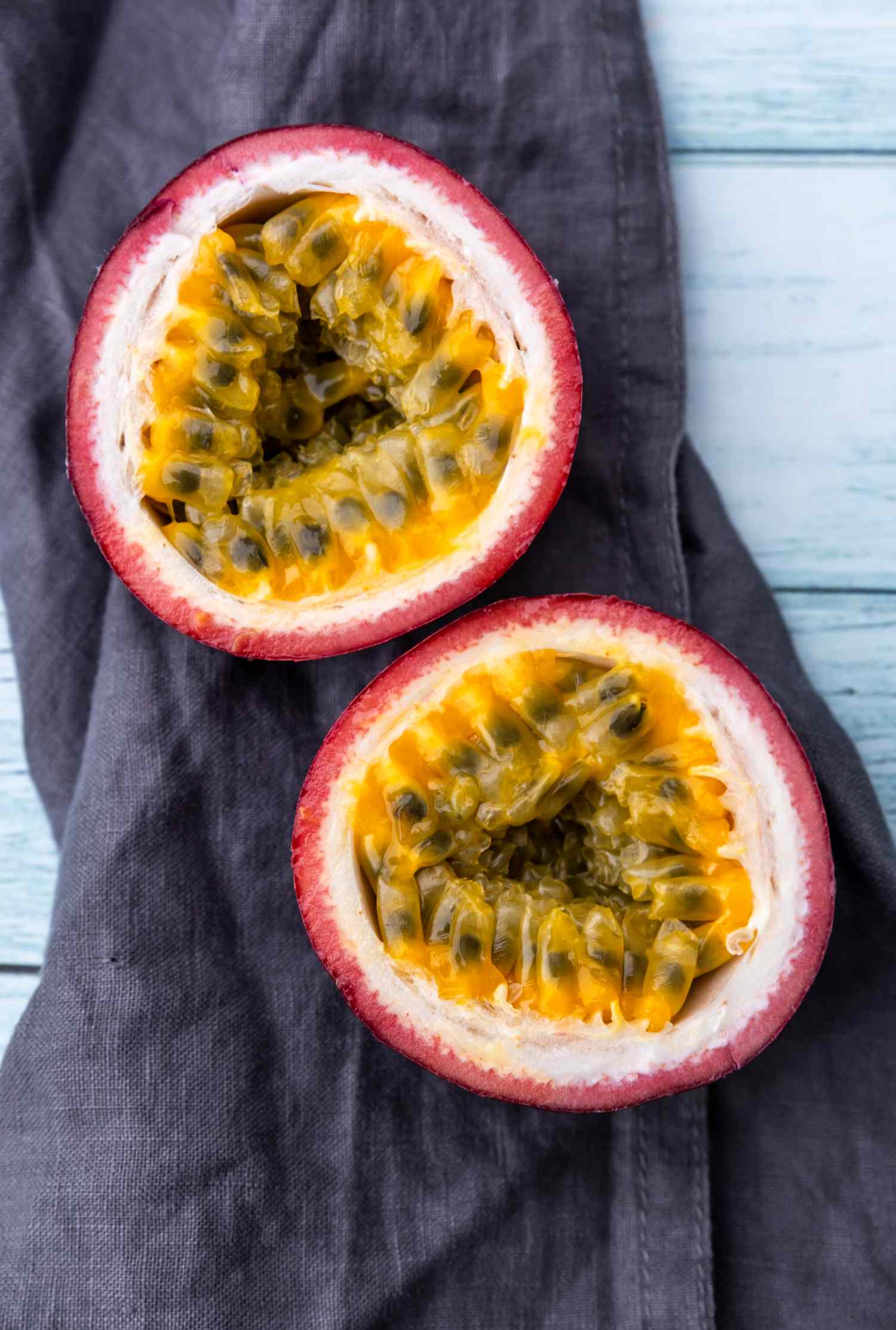 passion fruit halved on purple fabric