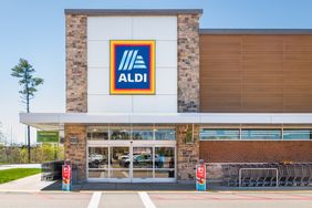 Front entrance of an Aldi store with shopping carts and signage displayed