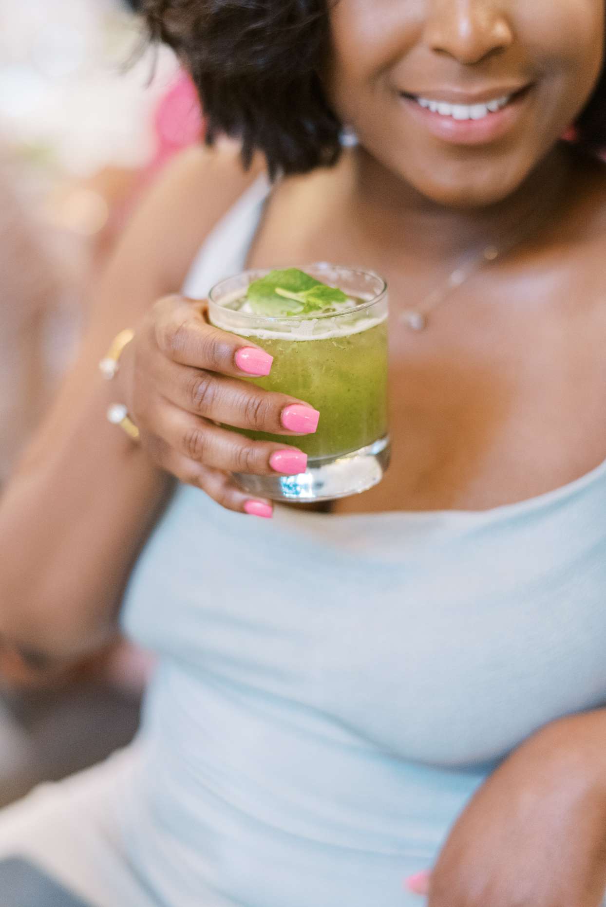 guest drinking green cocktail during wedding reception