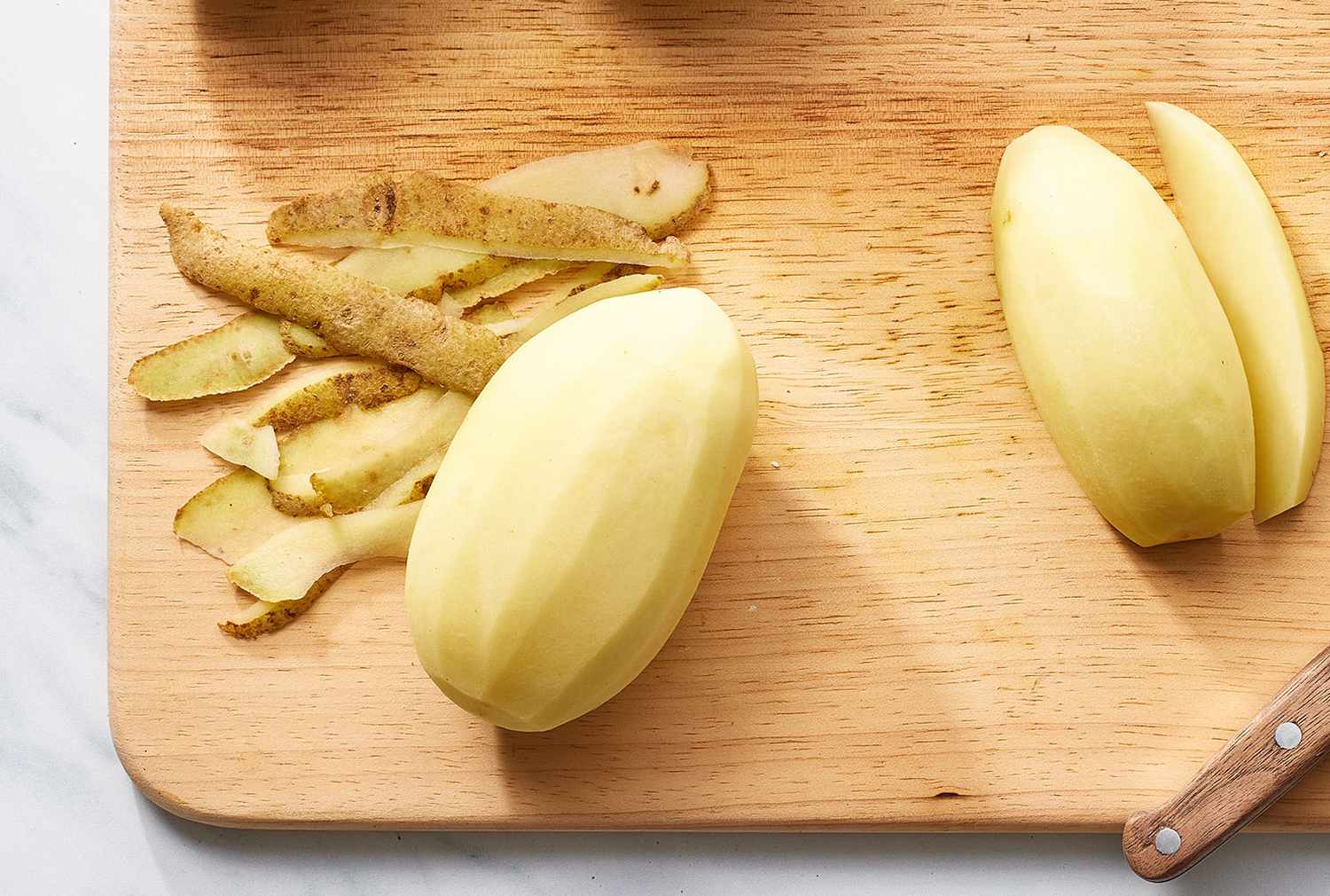 Potato peels on cutting board