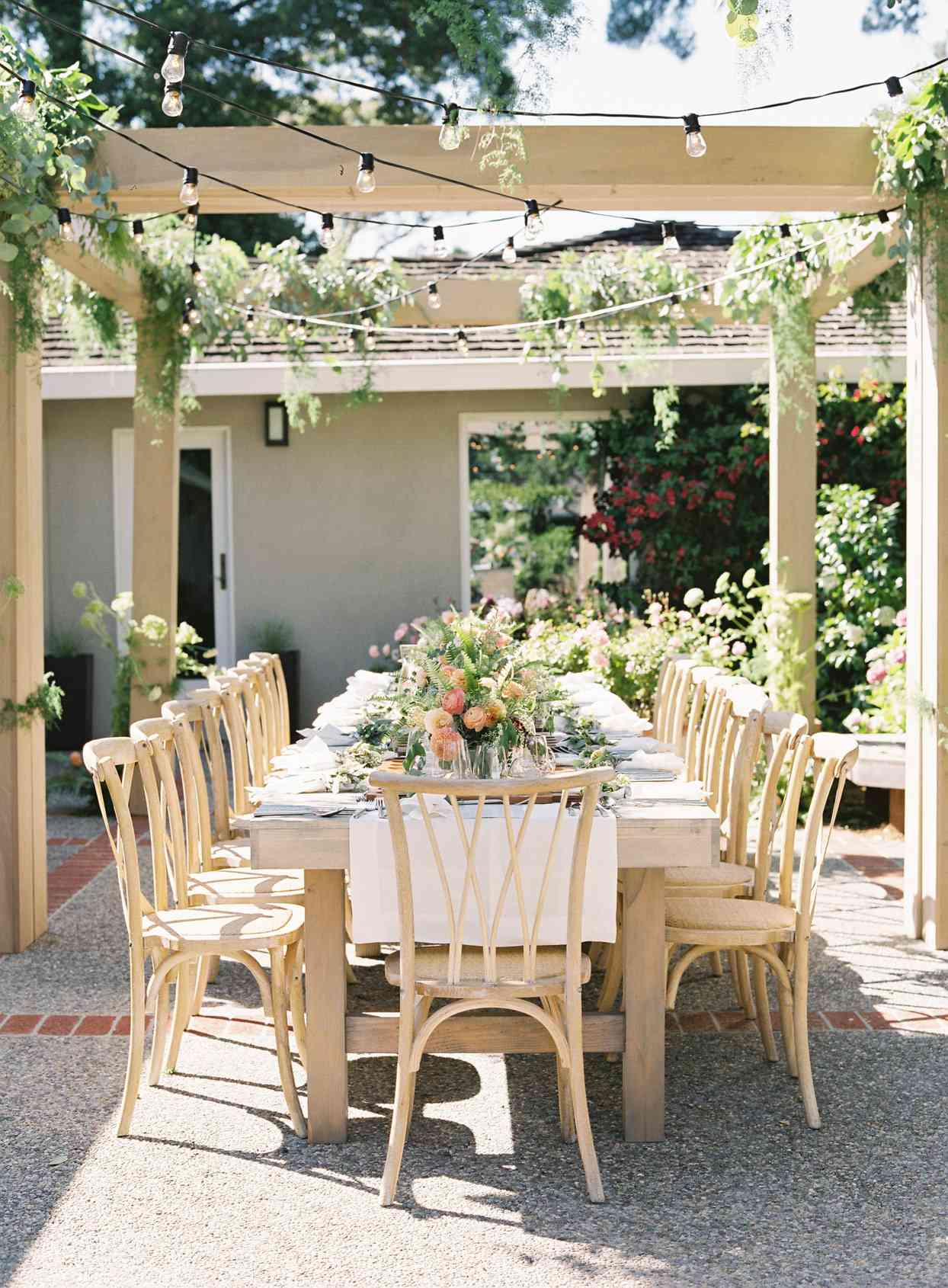 outdoor wedding reception table with string lights above