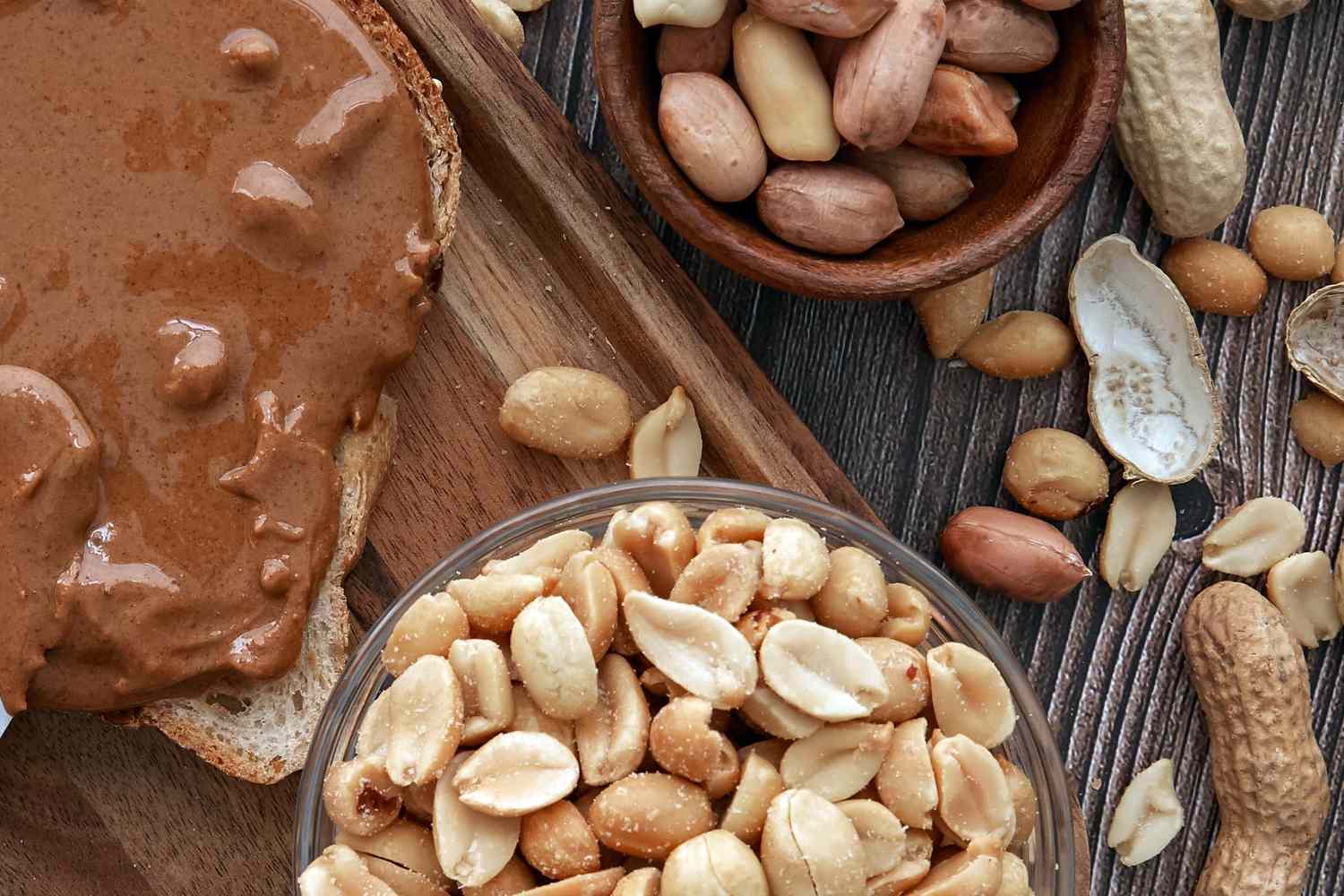 Peanuts in shells roasted peanuts and peanut butter on bread