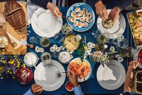 friends gathering around table outdoors