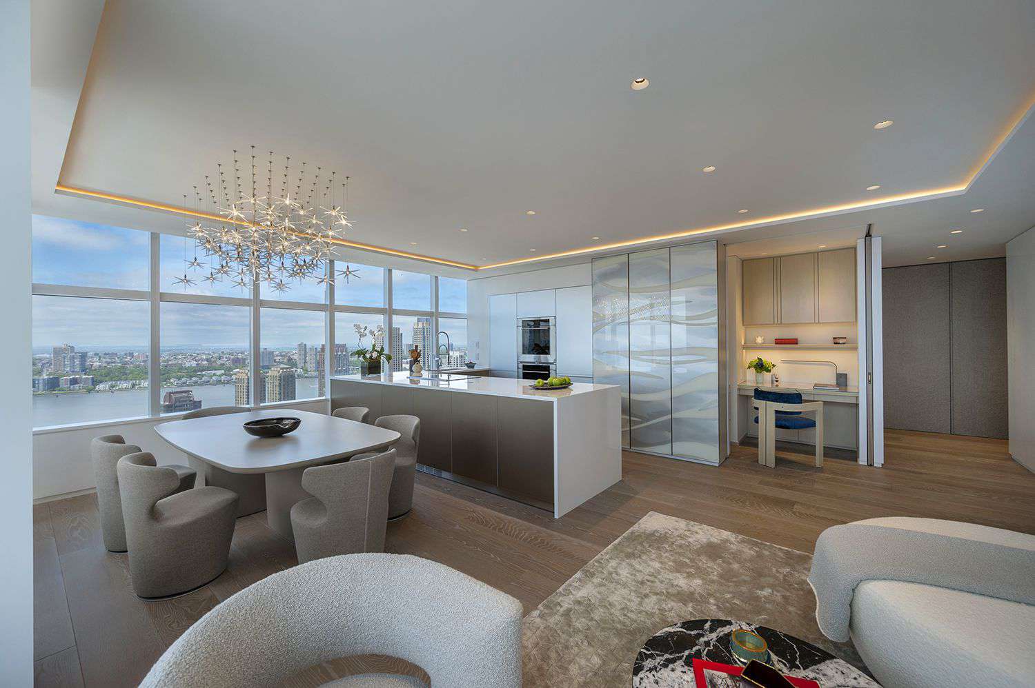 a white kitchen area with a hidden office 