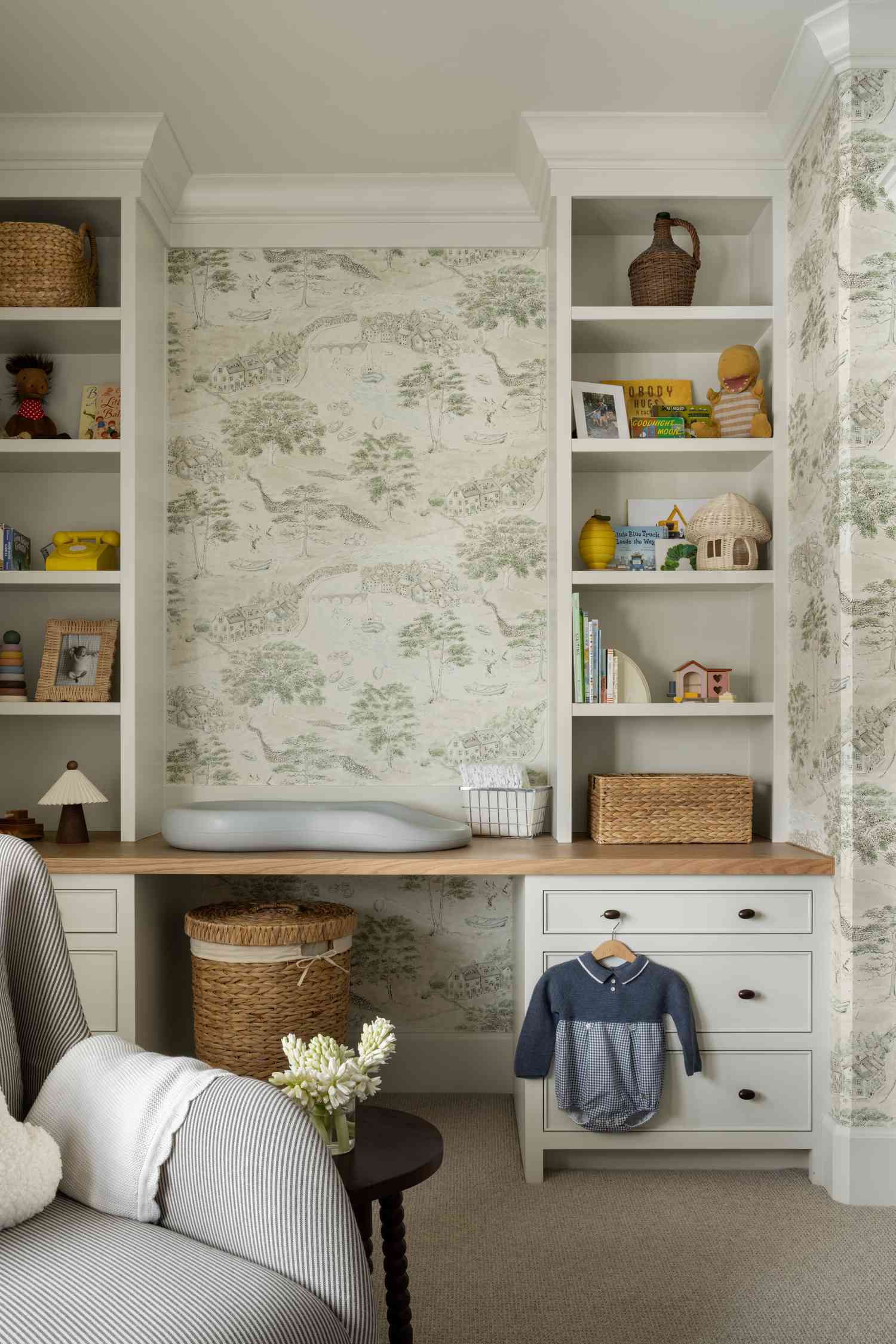 kid's room with green wallpaper and built-ins