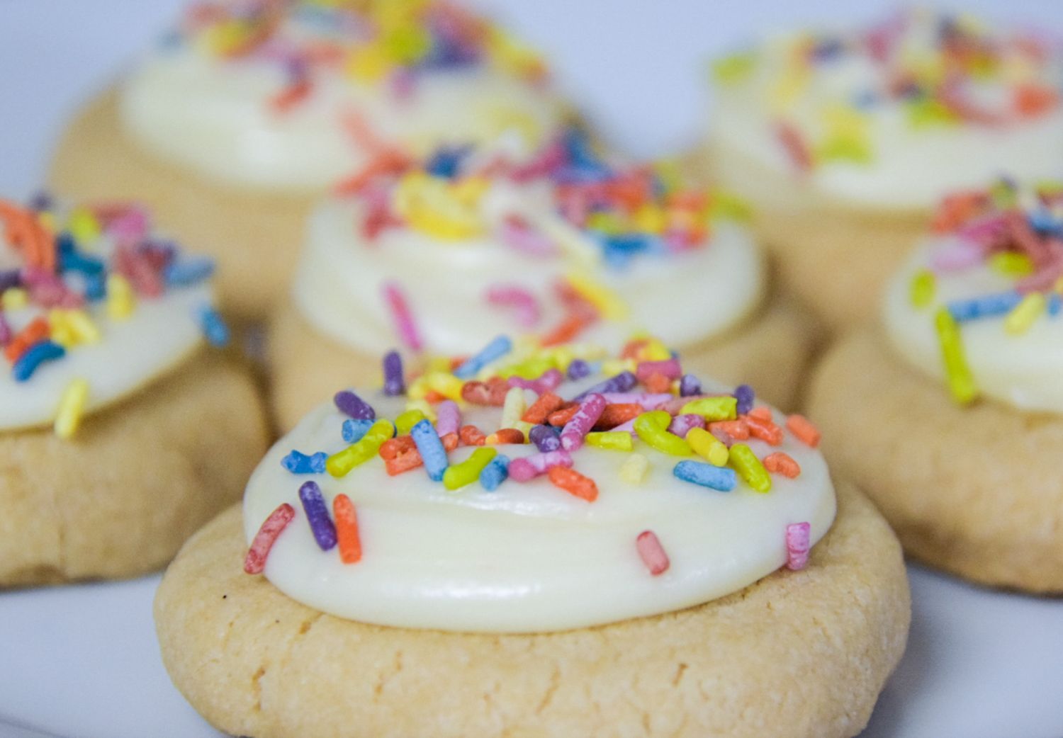 Frosted cookies topped with colorful sprinkles