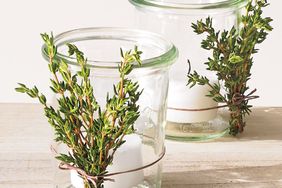 votice candle in jar with rosemary sprigs
