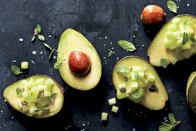 overhead view of halved avocados with chopped melon
