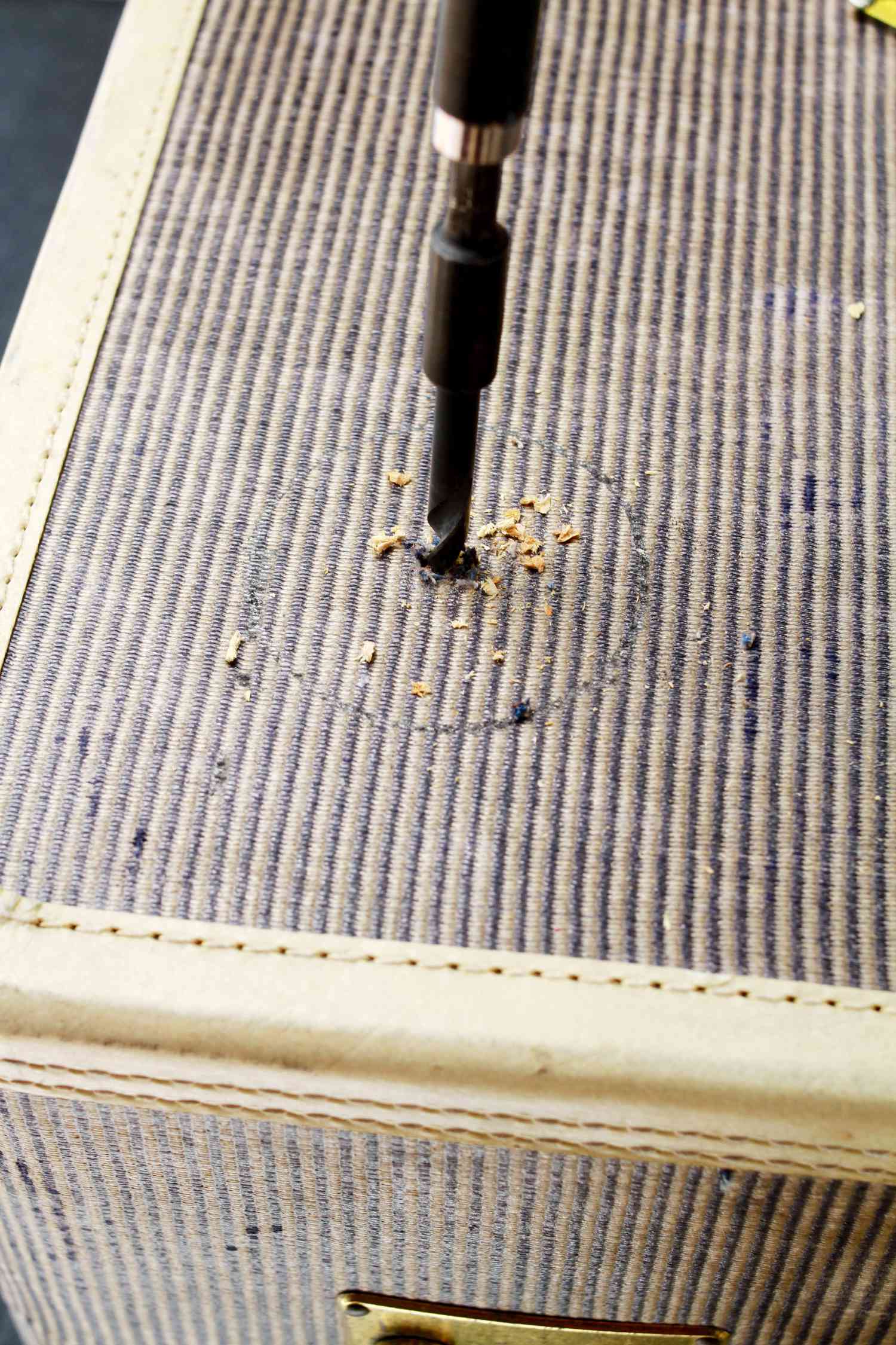 Drilling a hole into a suitcase
