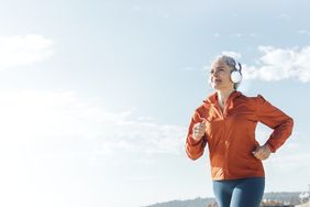 Person jogging outdoors wearing headphones
