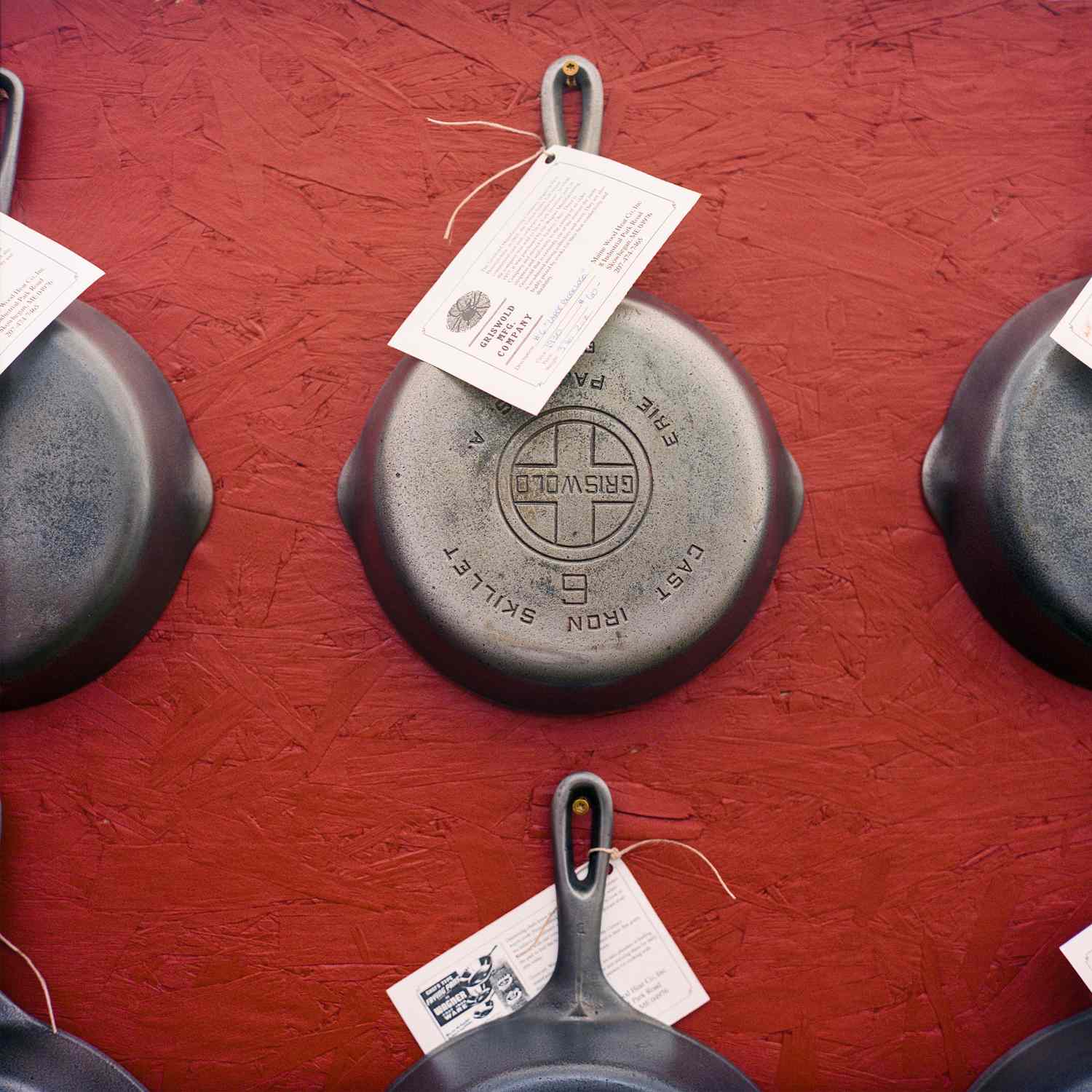 overhead view of iron skillets on a red background