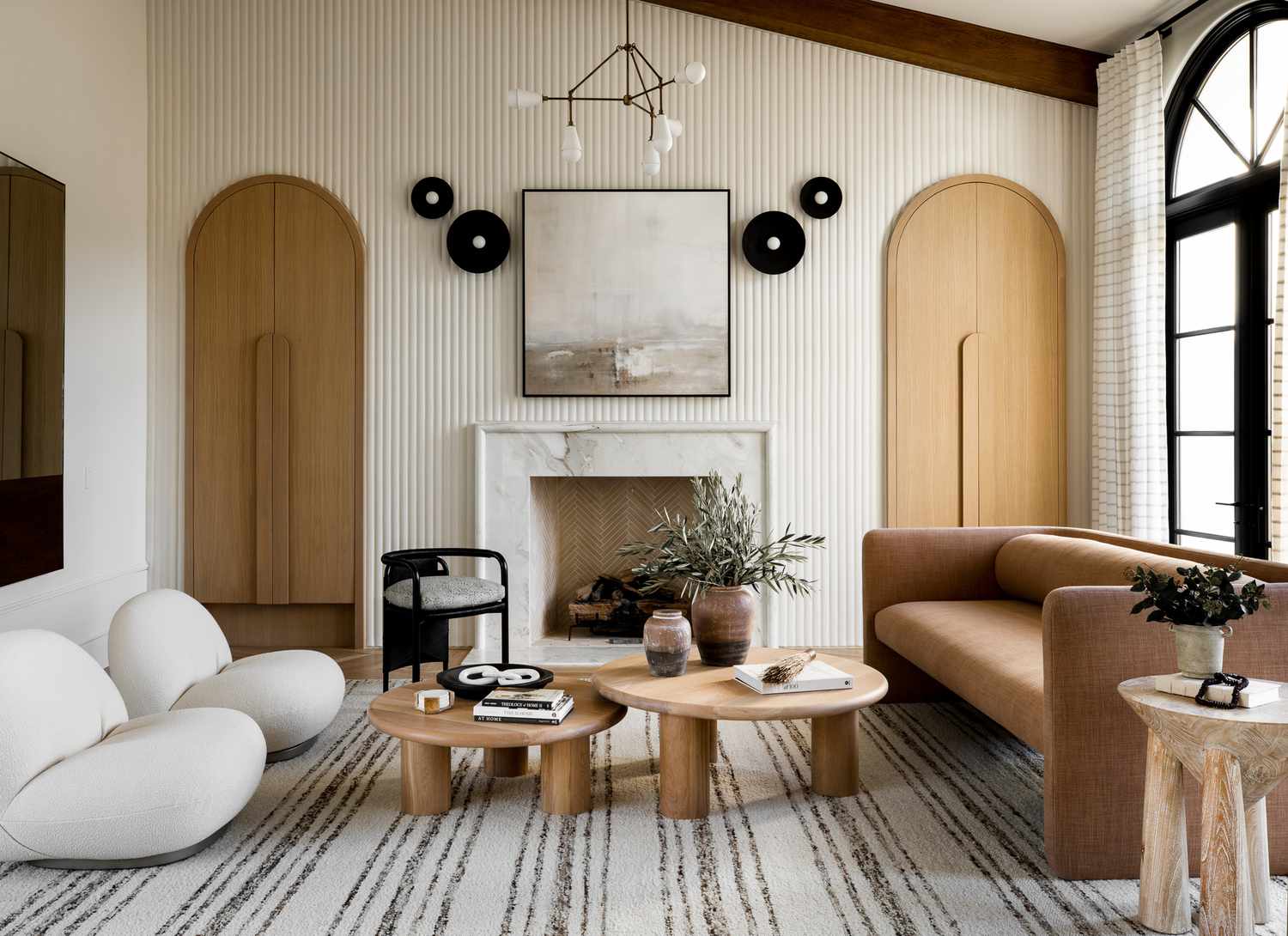 neutral living room with patterned rug and walls