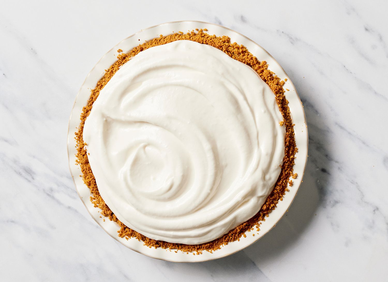 top view of meringue pie in white pie dish