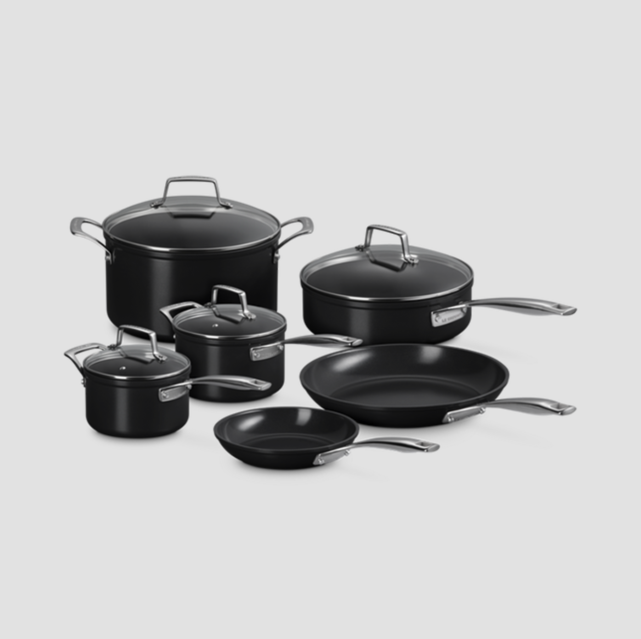 Set of black cookware including pots and pans with lids