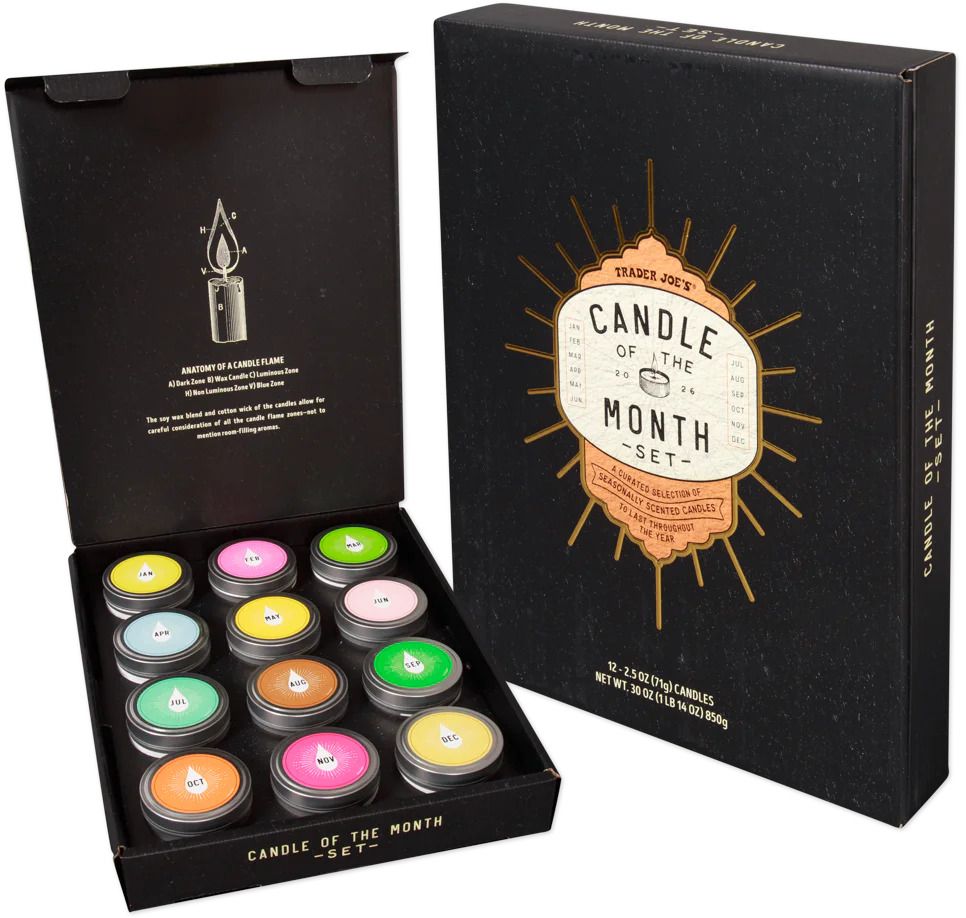 Open box of a candle of the month set featuring various small candles in different colors