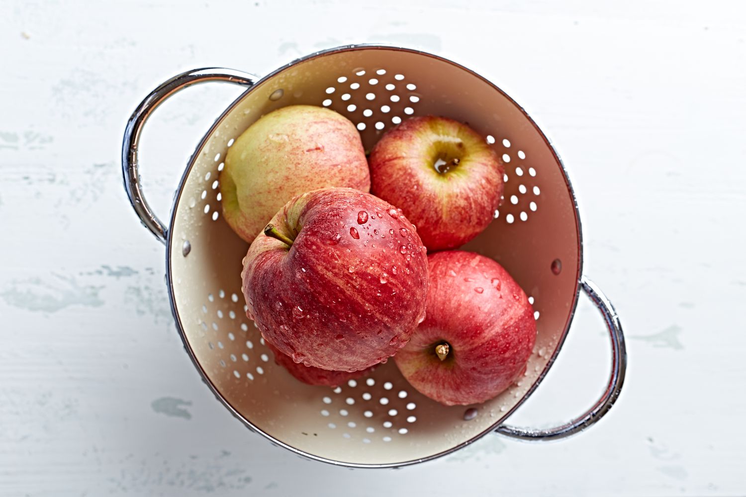 Freshly washed apples in a colander