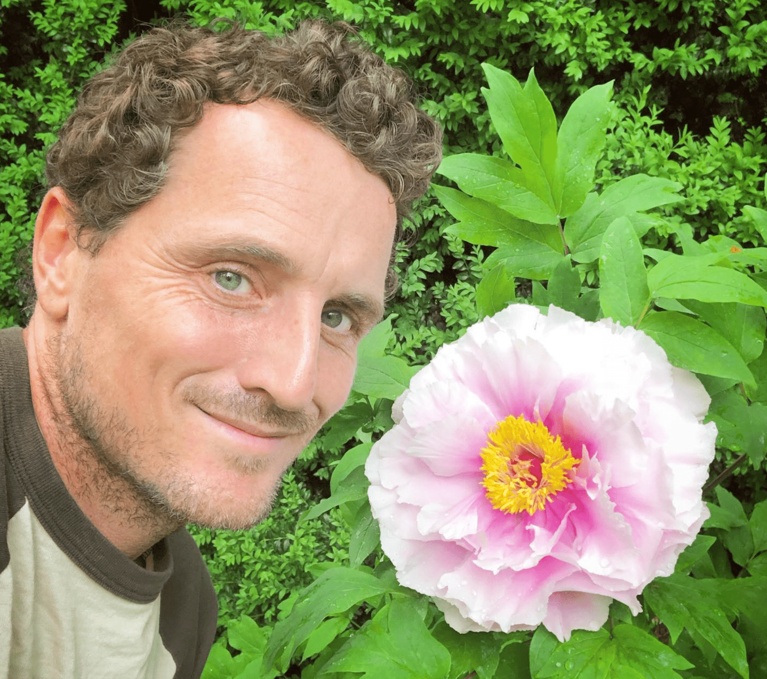 Ryan McCallister next to a peony