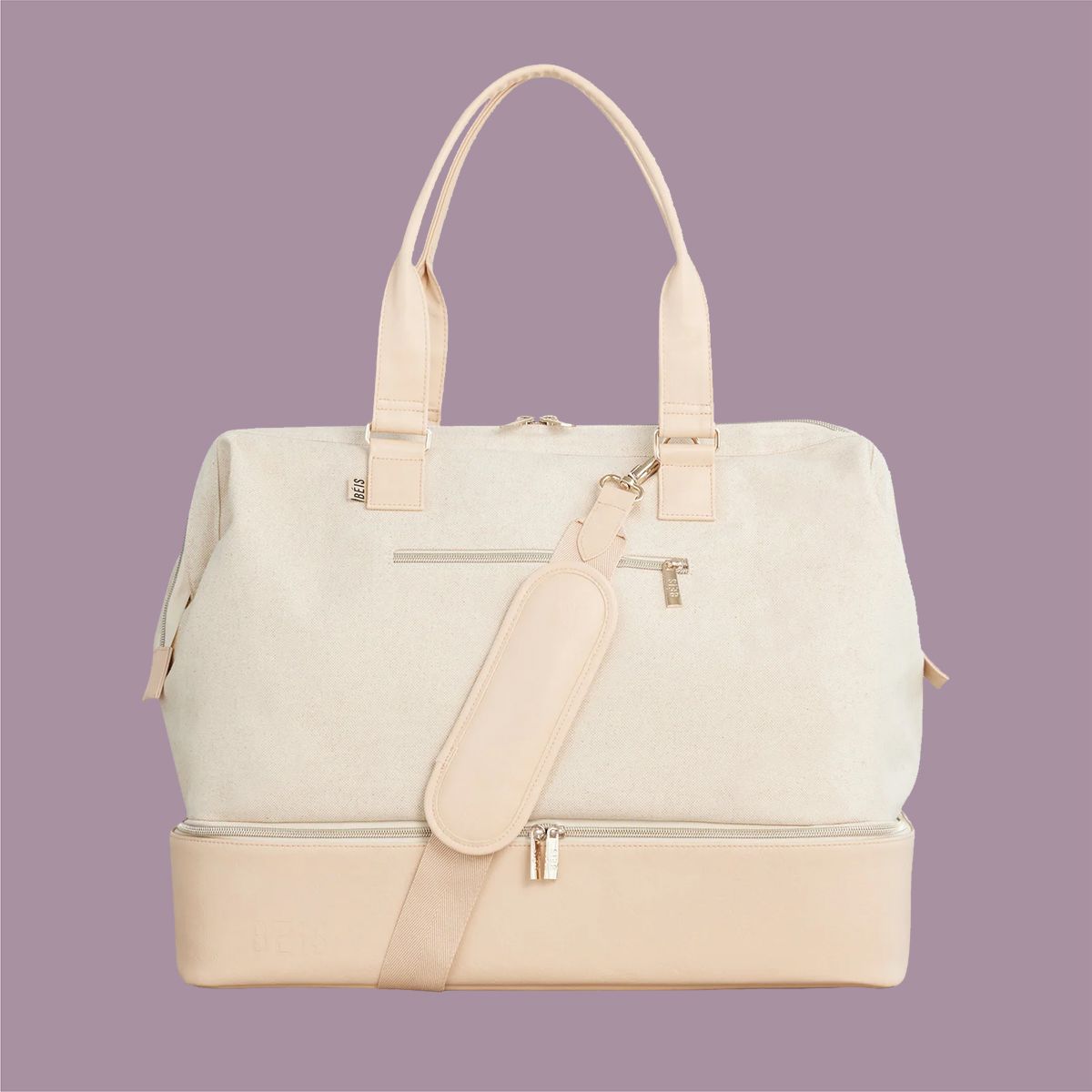 beige weekender travel bag on a purple background