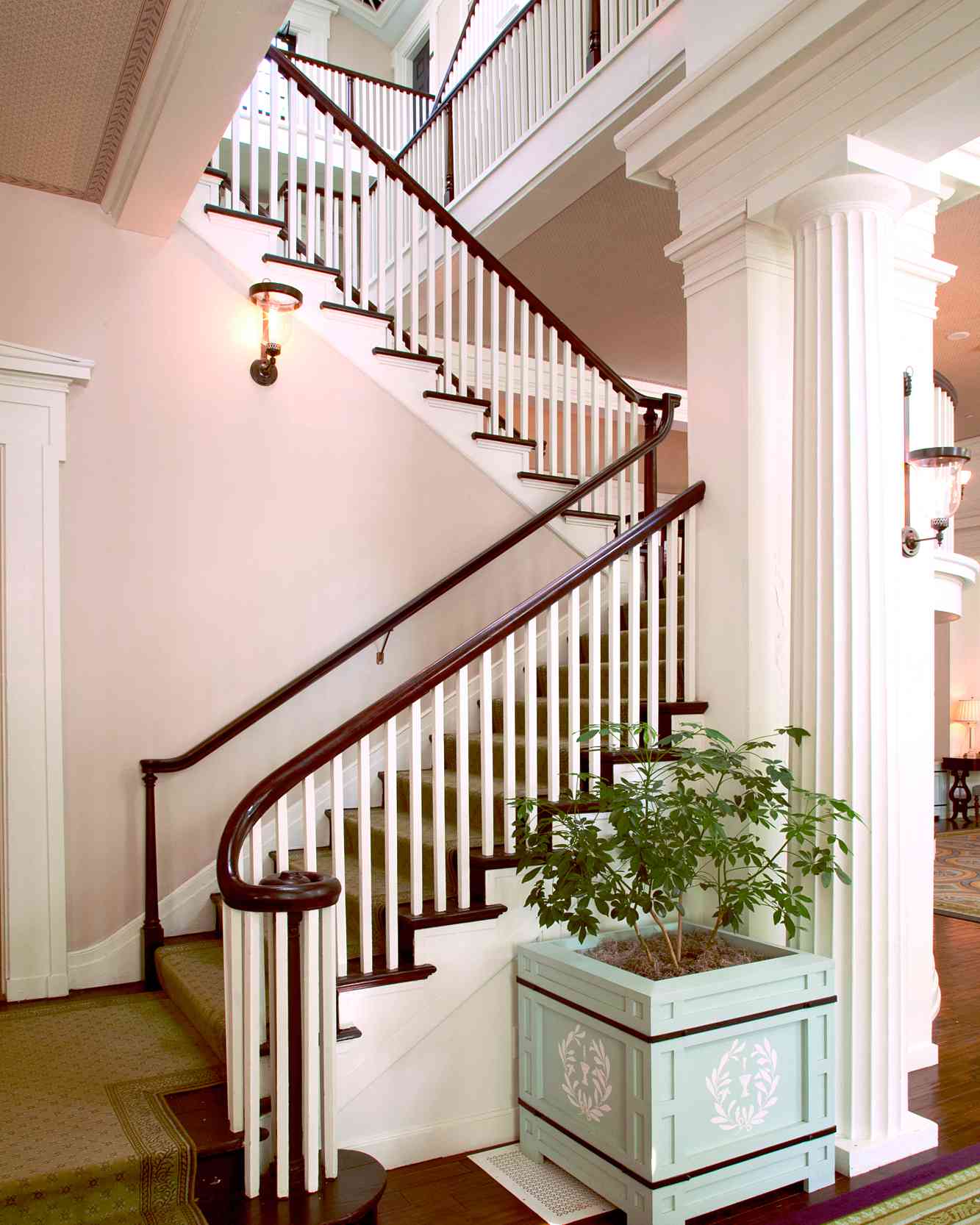 A staircase with light pink walls