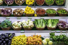 Fruits and vegetables on a supermarket shelf.