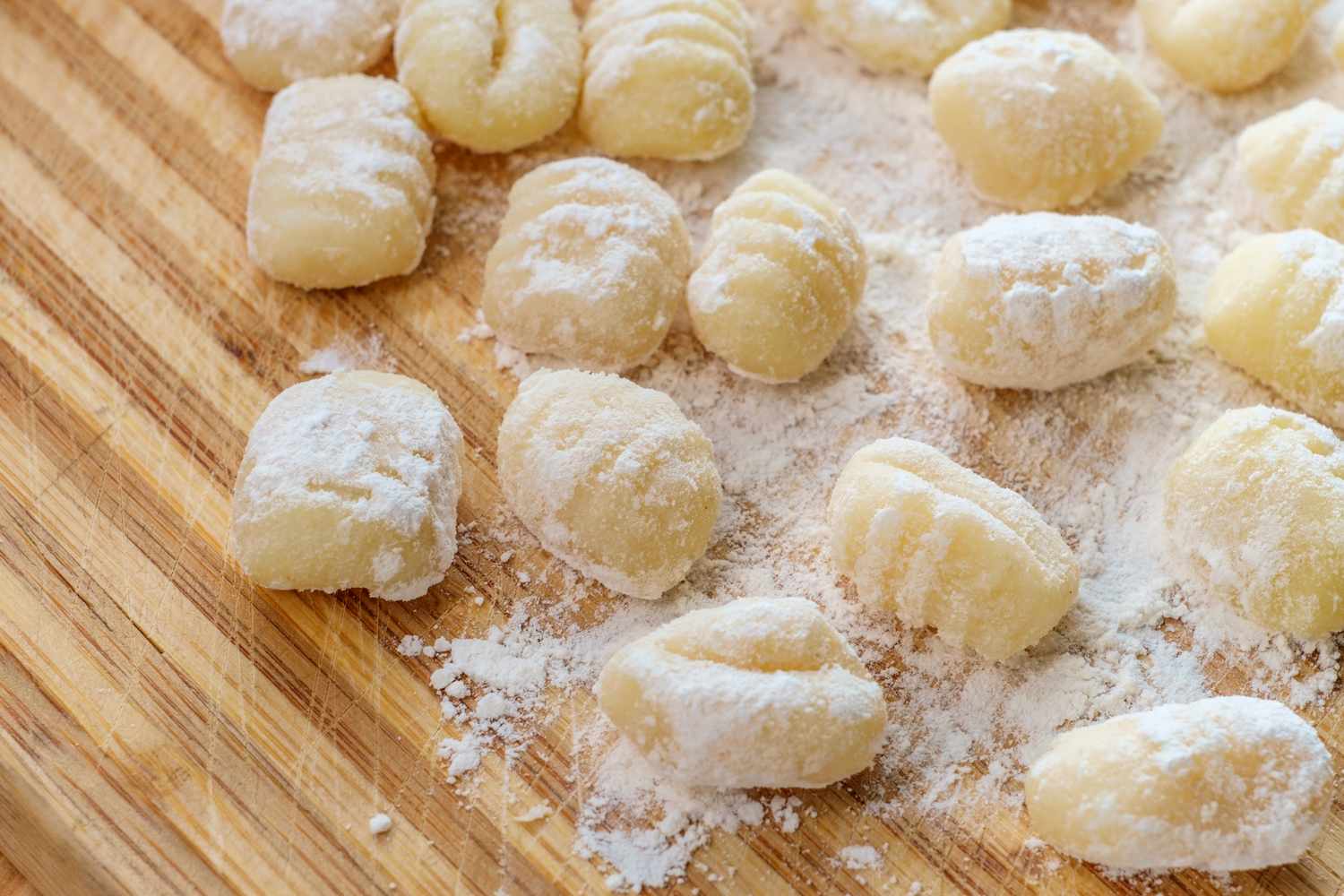 Homemade gnocchi with flour on a wooden countertop