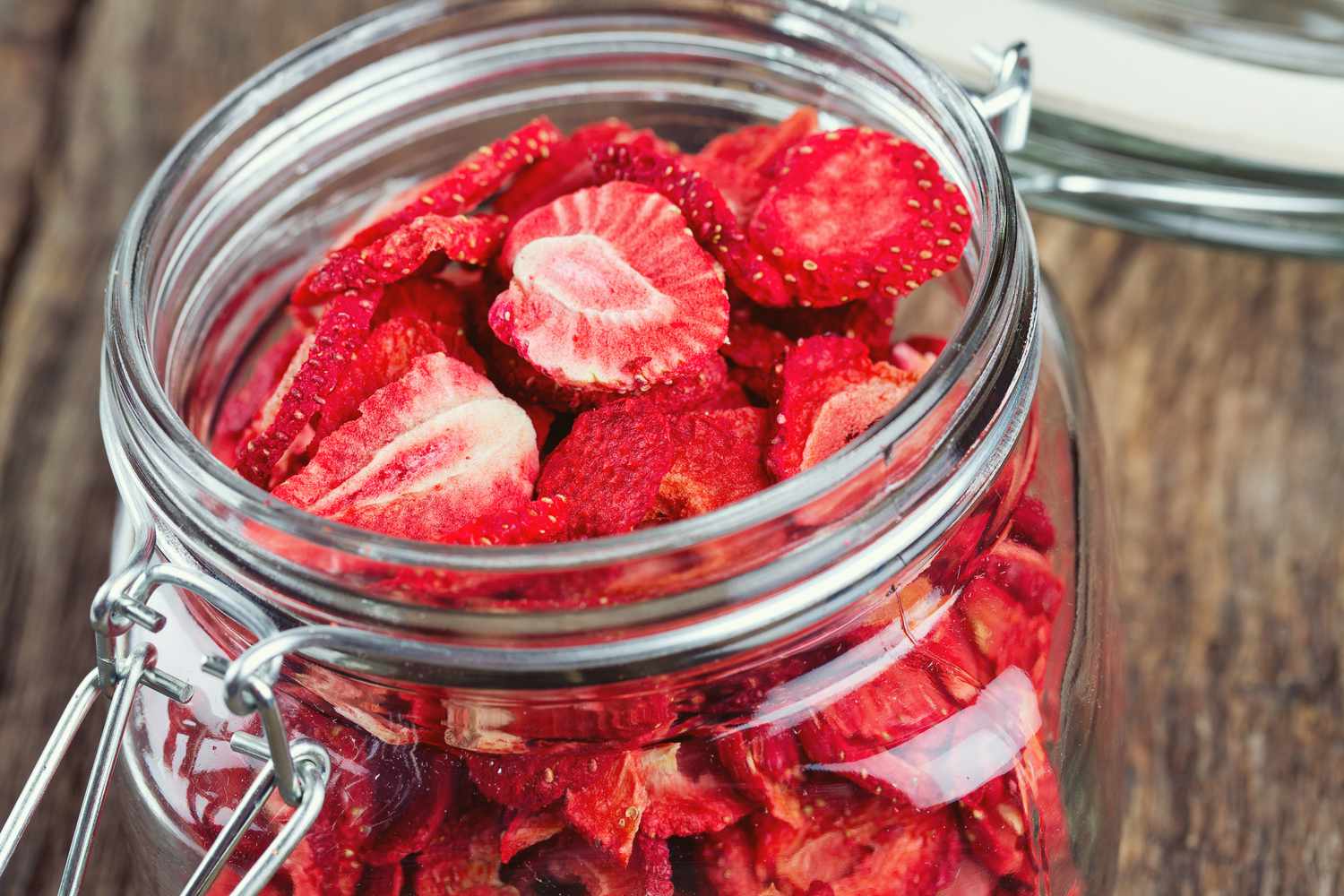 dried strawberries in an open glass jar