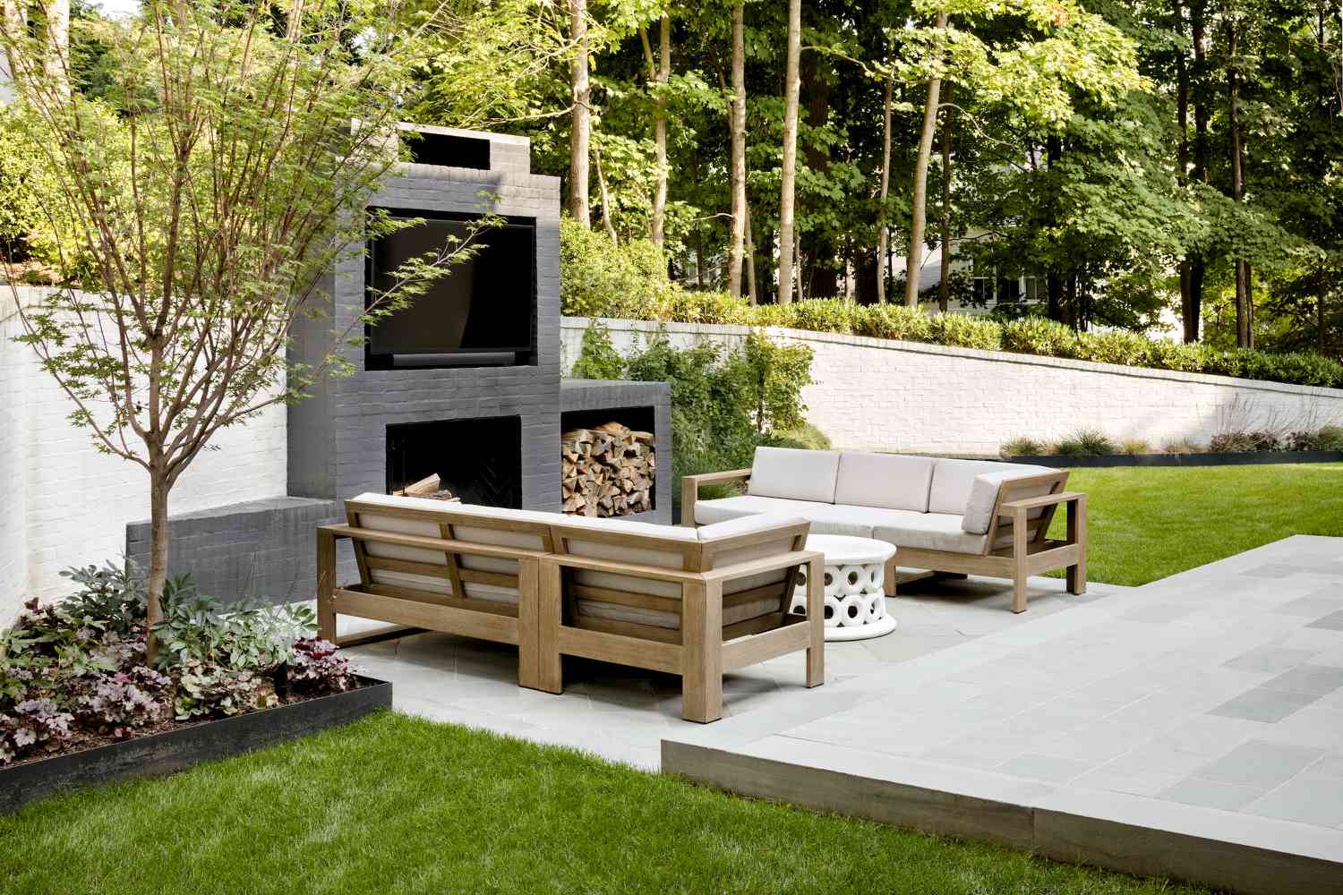 outdoor patio with fireplace and tv