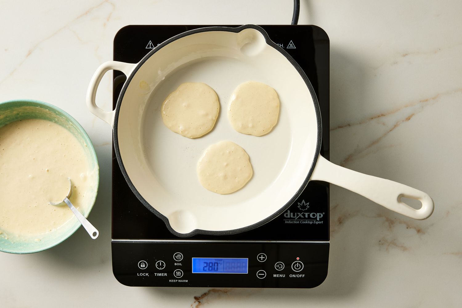 Silver dollar pancakes cooking on skillet