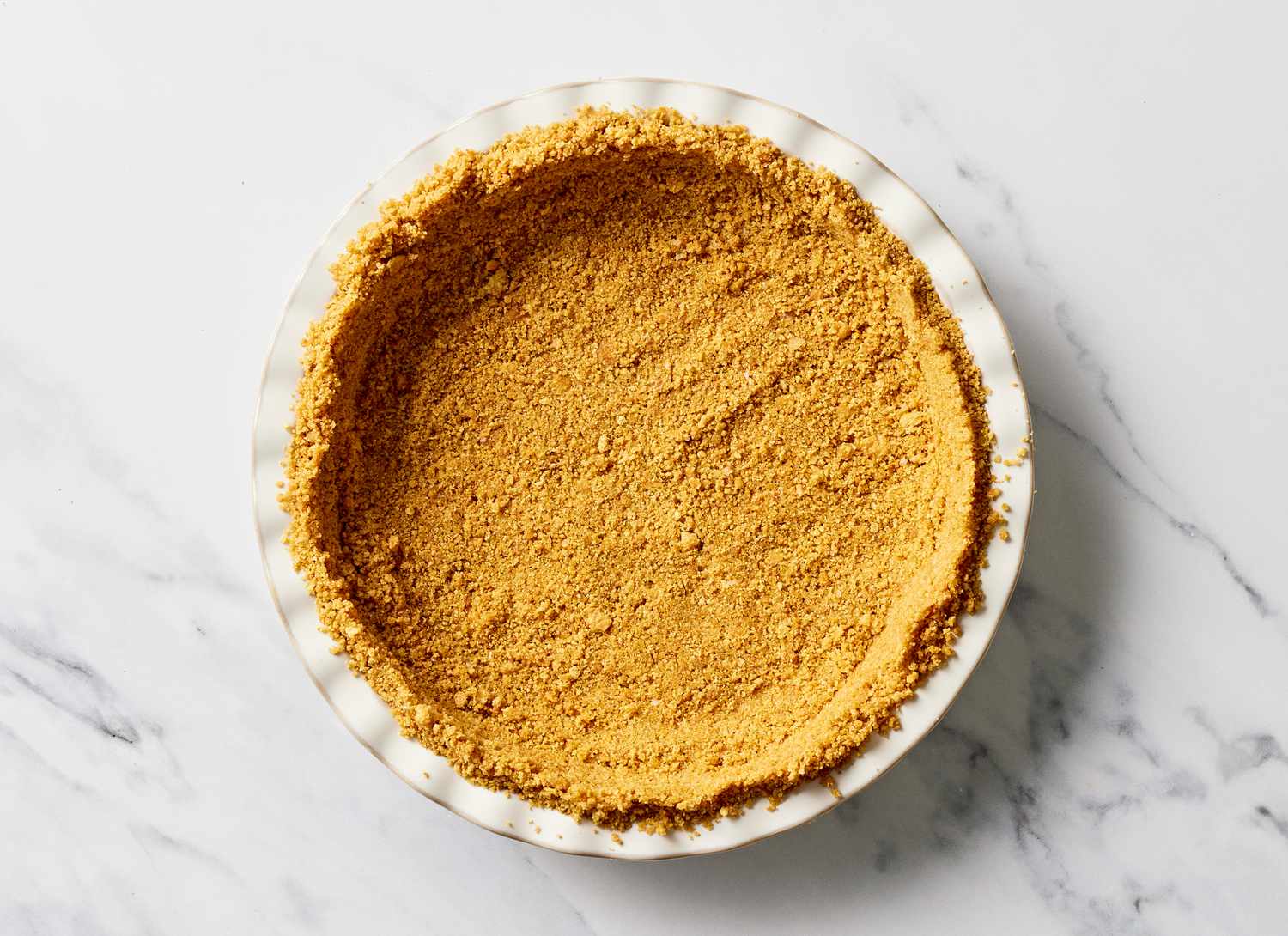 pie crust in a white pie dish