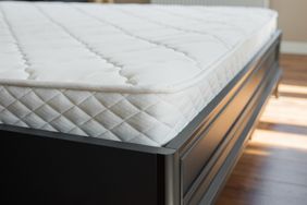 Bare mattress on bed frame