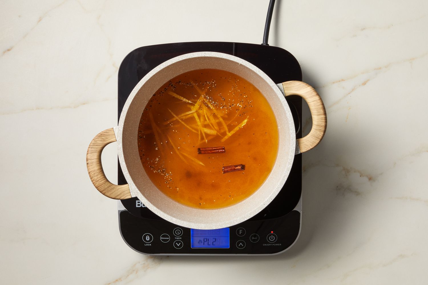 overhead view of cooking liquid on burner