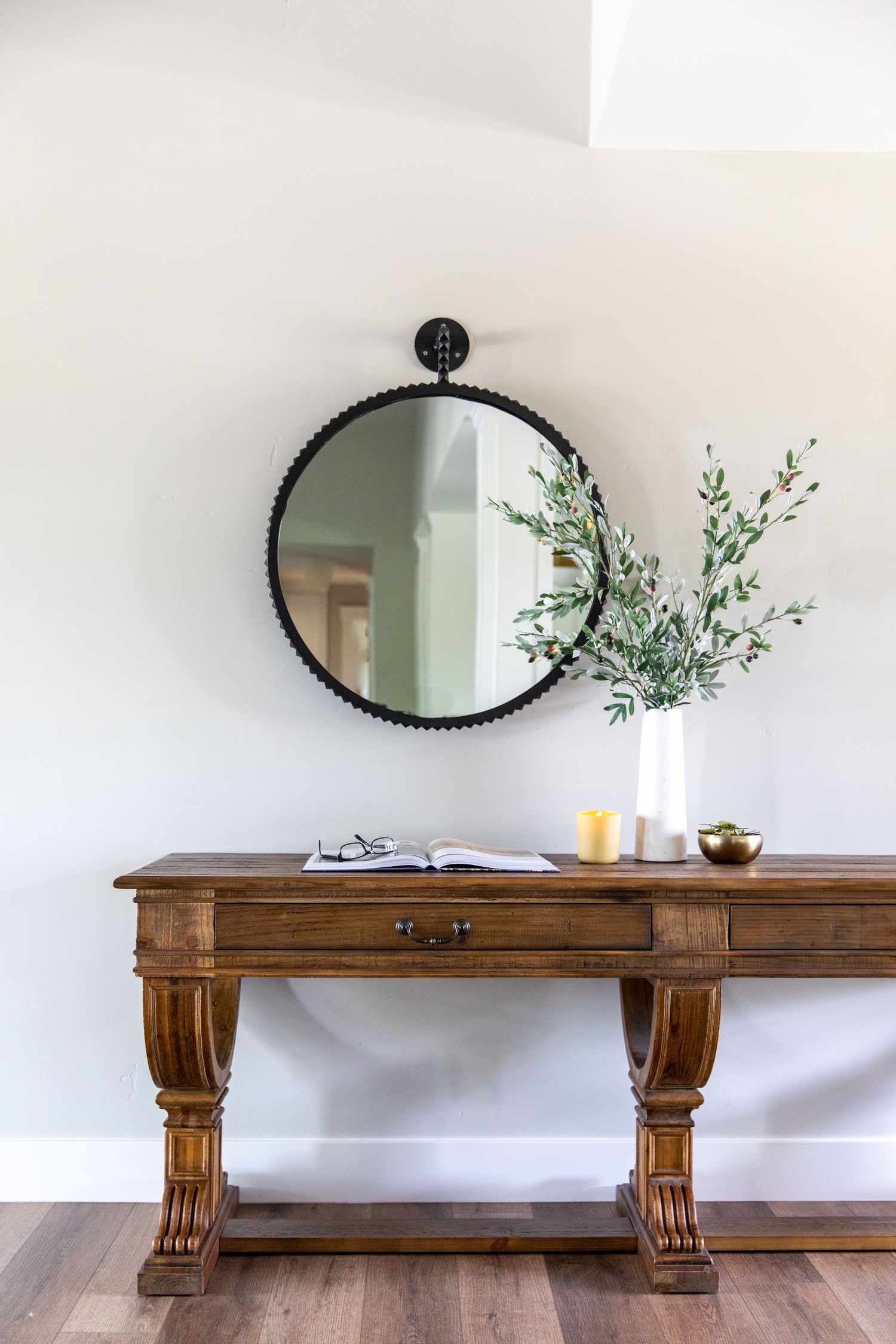 Entryway with wooden table and decorative mirror