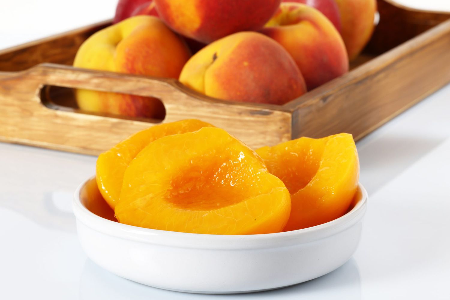 fresh peeled halved peaches in bowl
