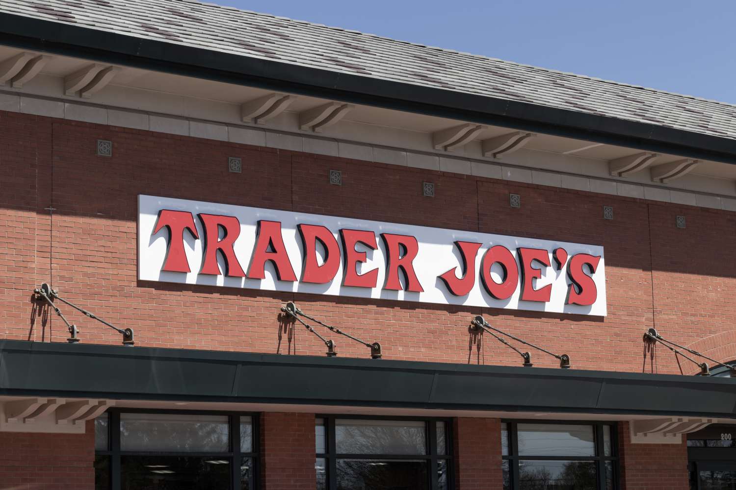 Facade of a Trader Joes store with the store name in bold letters on a brick building