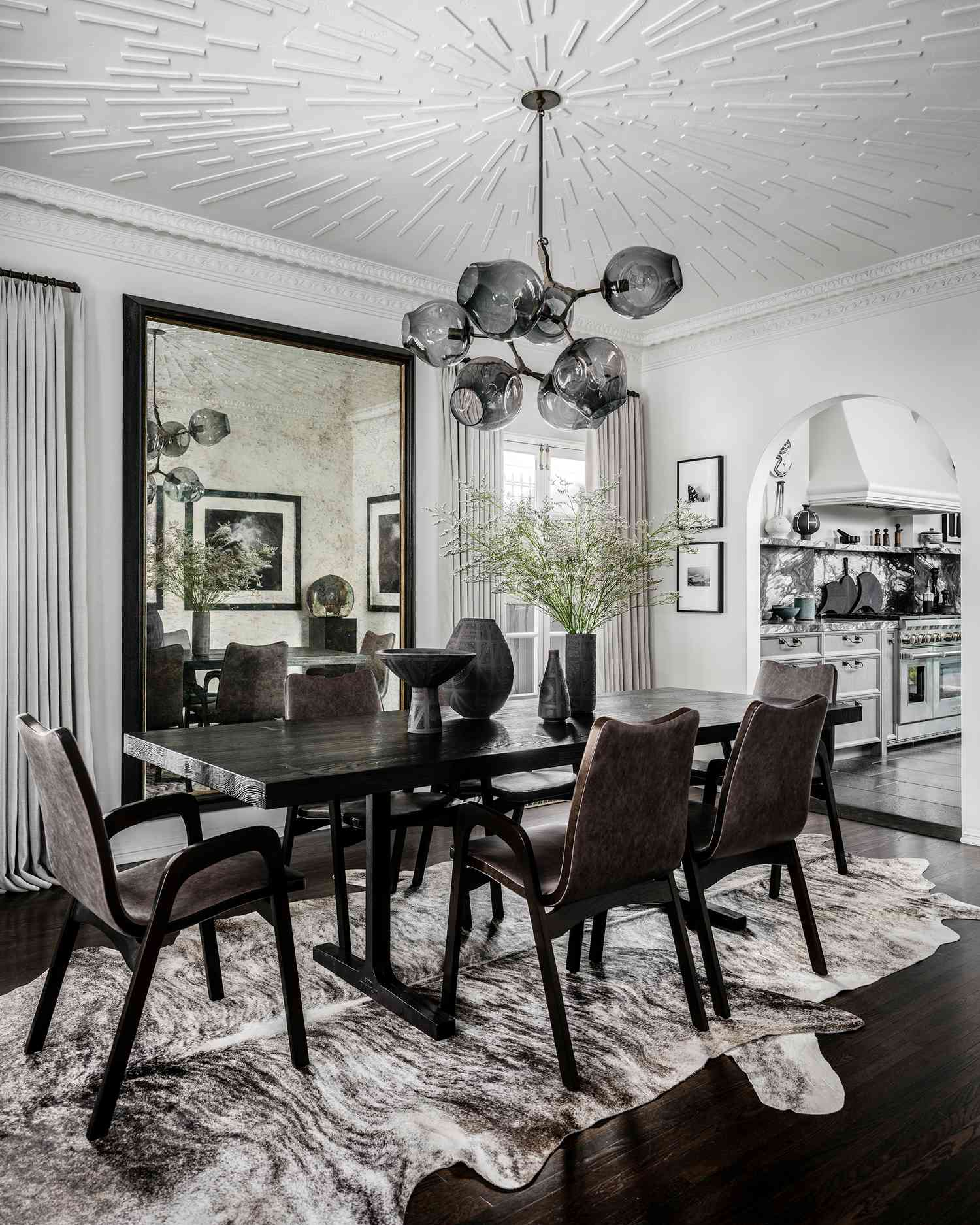 high contrast dining room with black table and chandelier