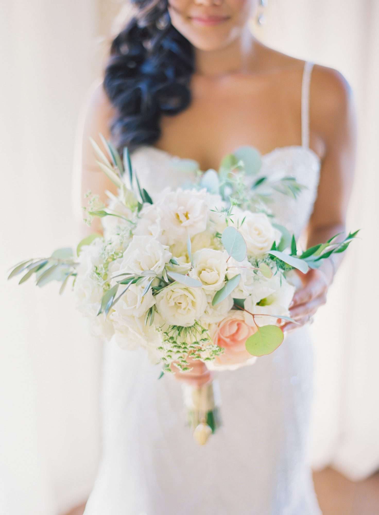 bride holding white bouquet