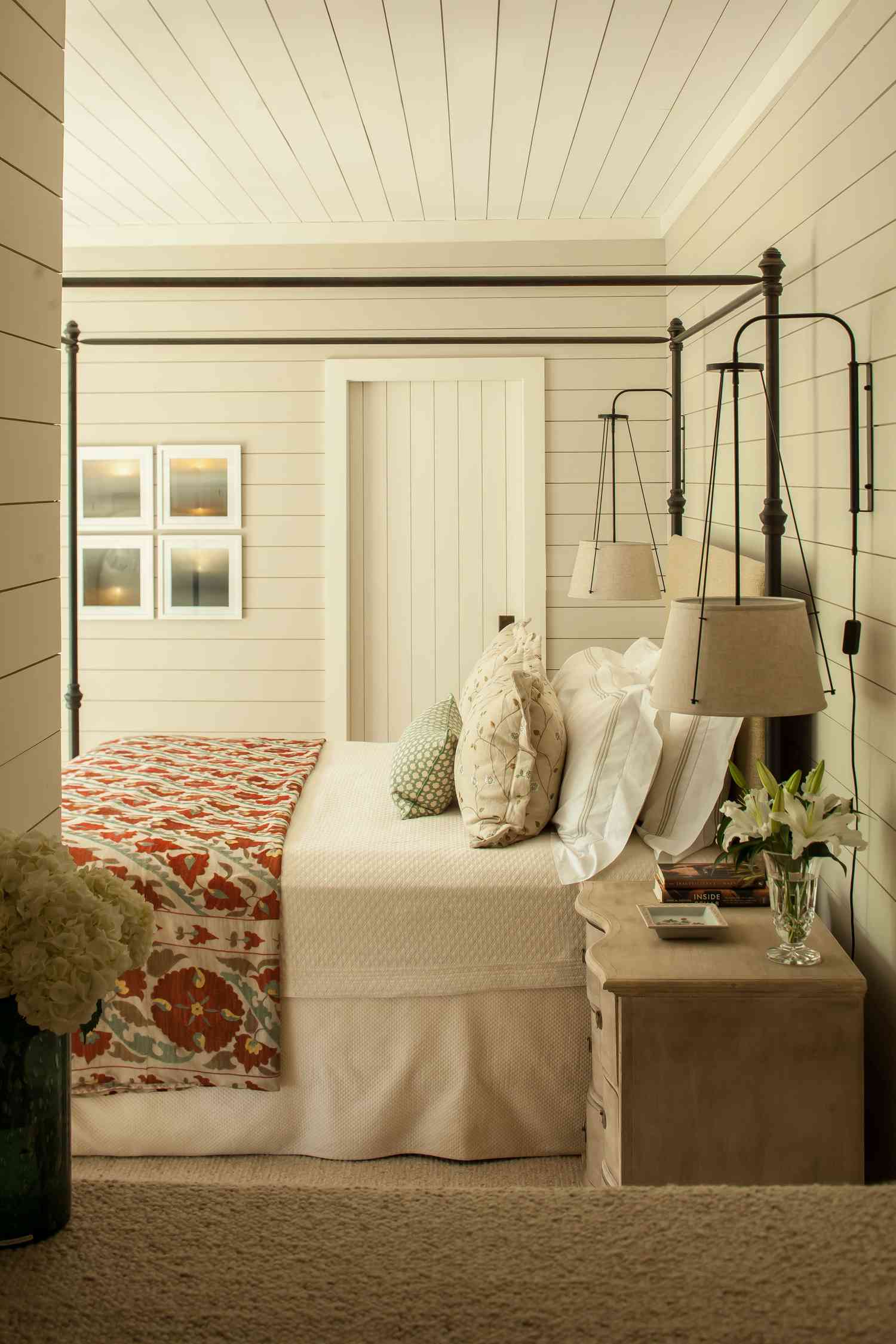 white bedroom with lights framing the bed 