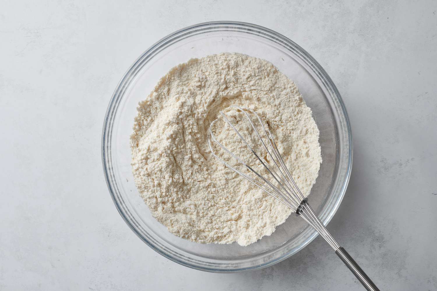 whisking flour in bowl