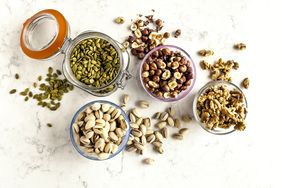 nuts and seeds in glass jars from above