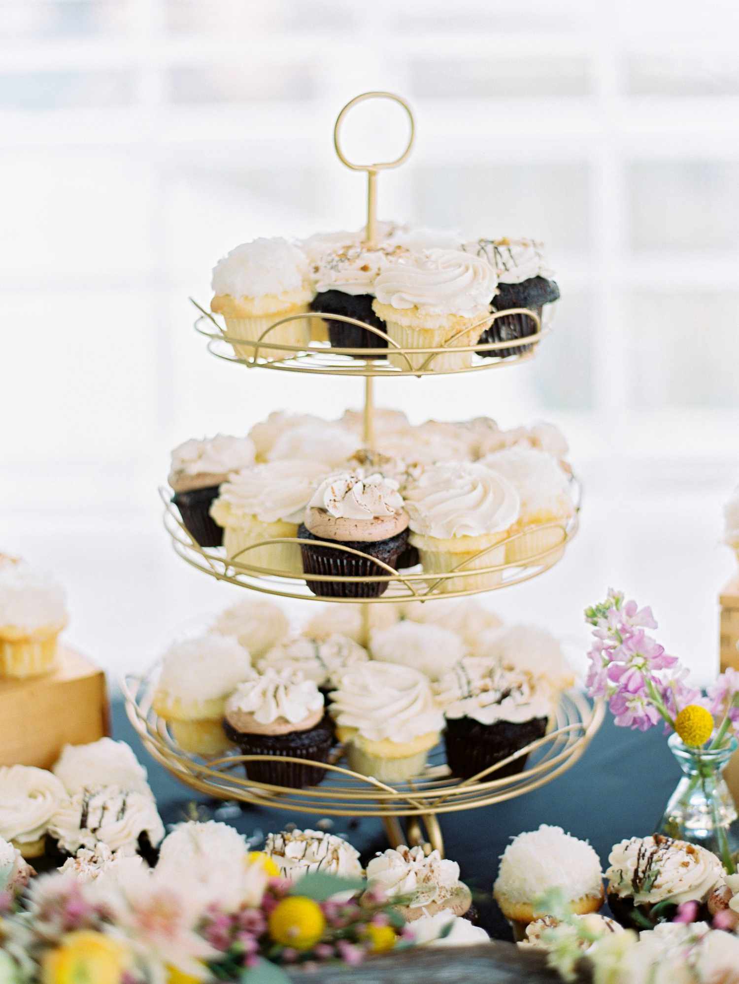 chocolate and vanilla cupcakes on a tier