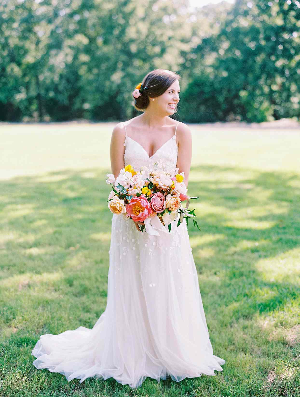evie joe wedding bride with colorful bouquet in field
