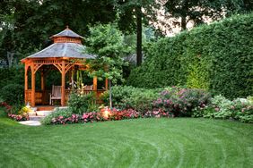 beautiful lawn with flowers and gazebo