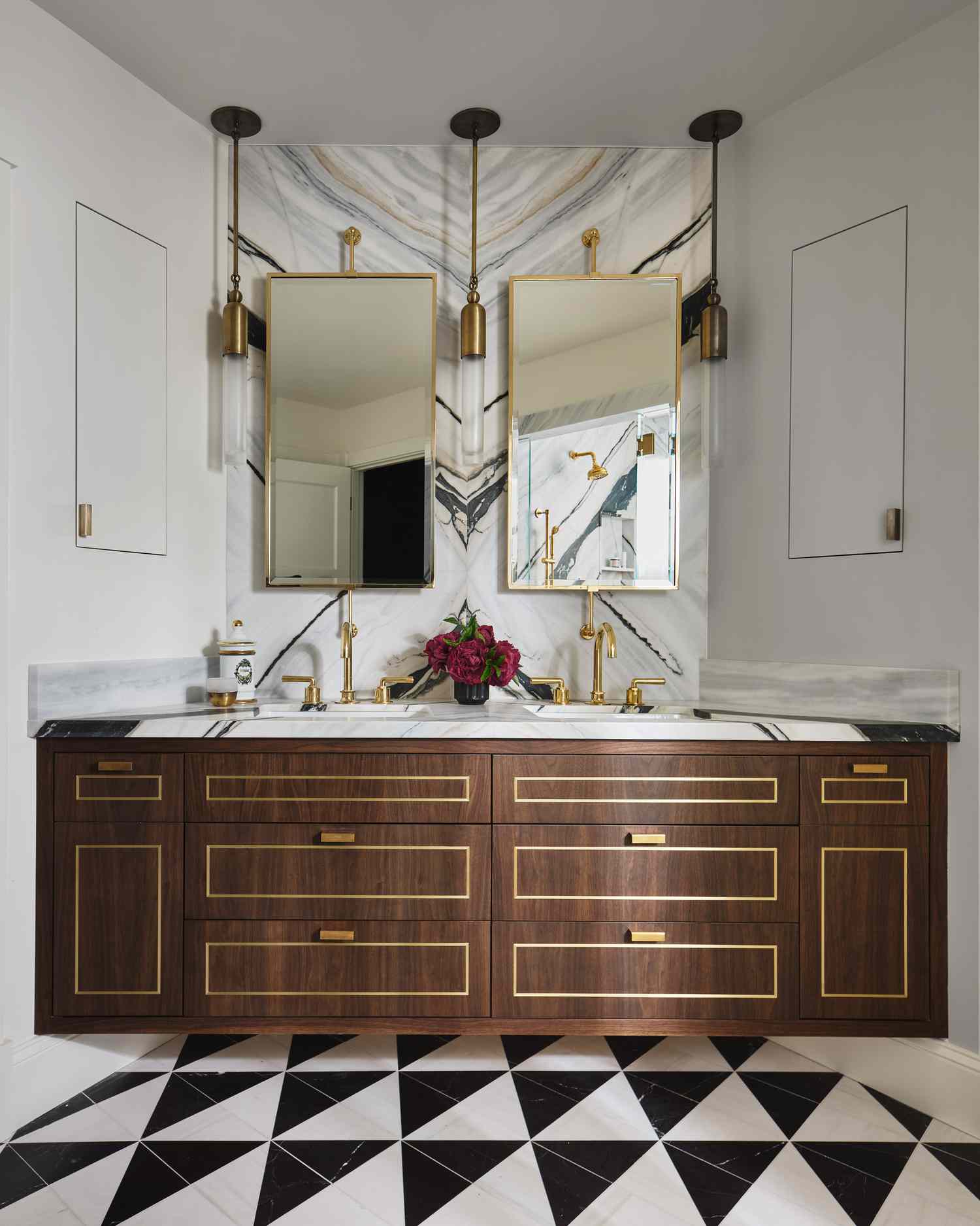 white bathroom with gold accents and mirrors