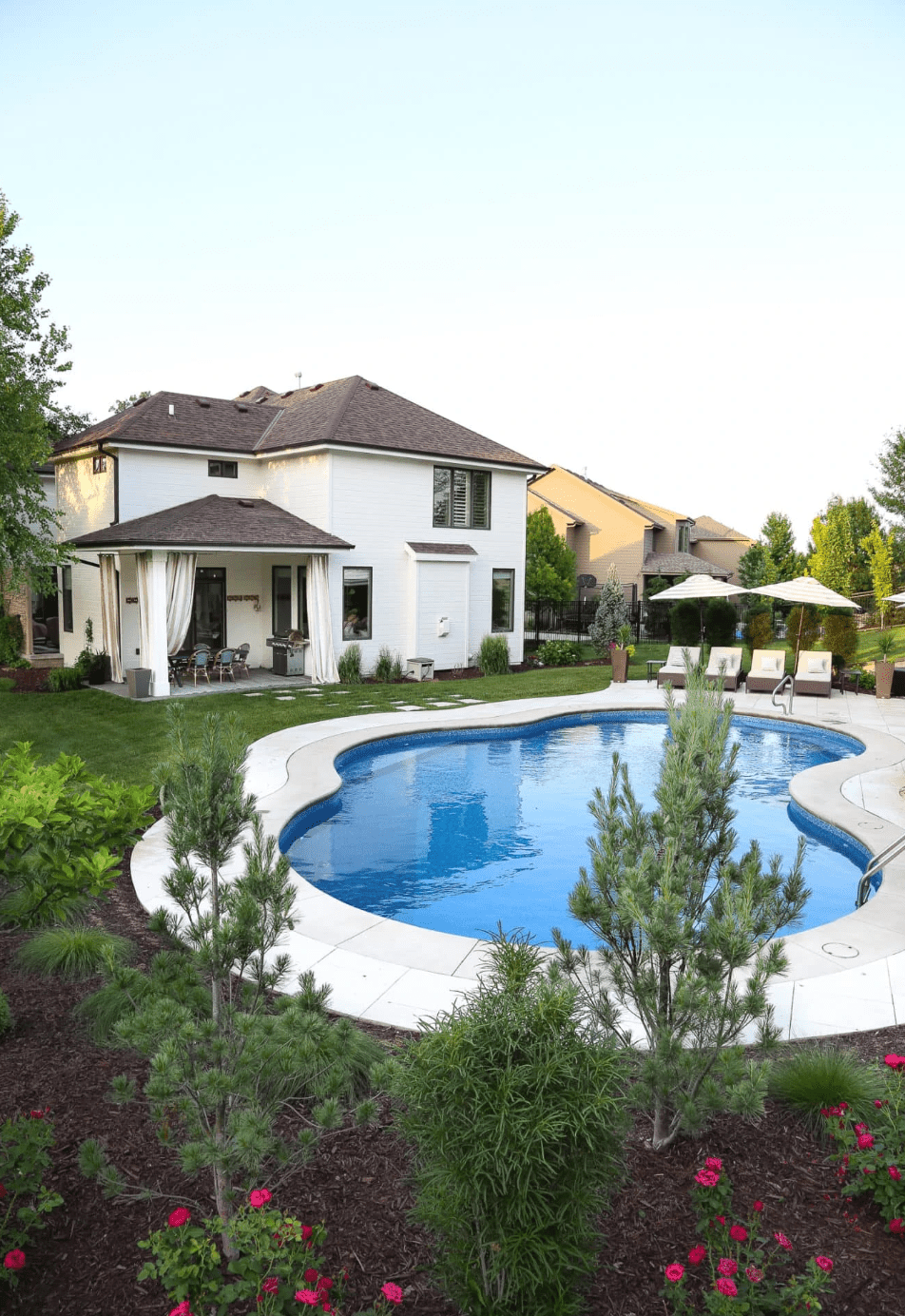 white home with large backyard pool