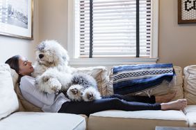 woman on couch with old english sheep dog