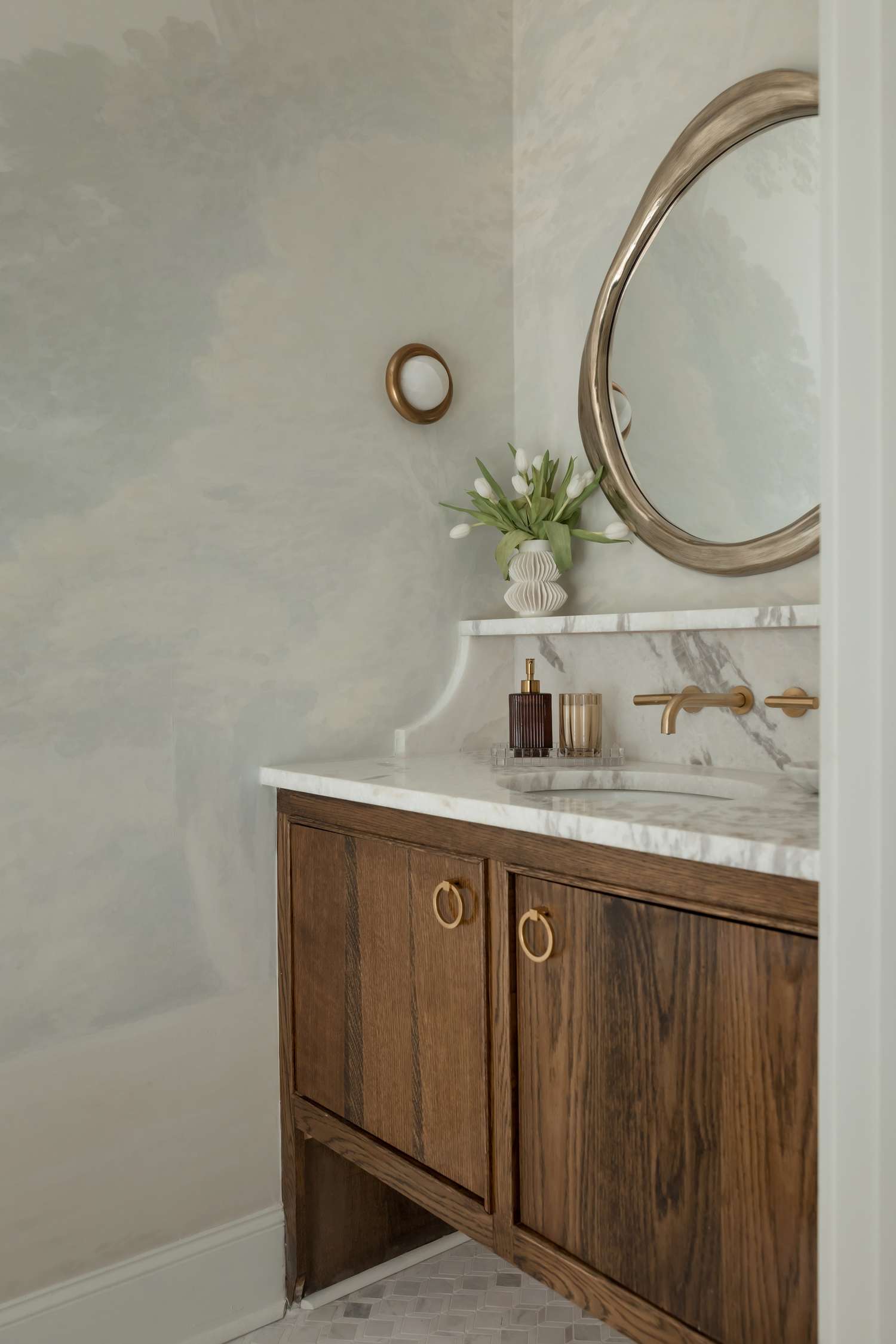 A powder room with subtle cloud motif wallpaper