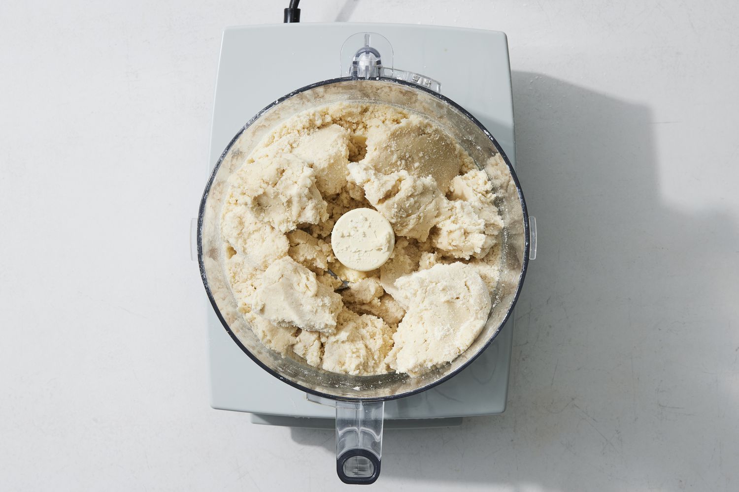 overhead view of food processor with dough