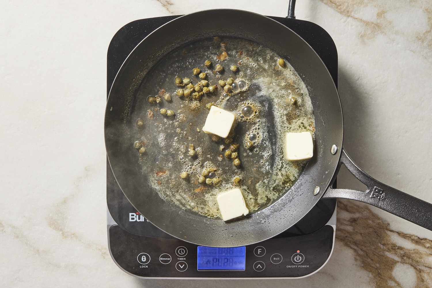 Capers and butter in pan