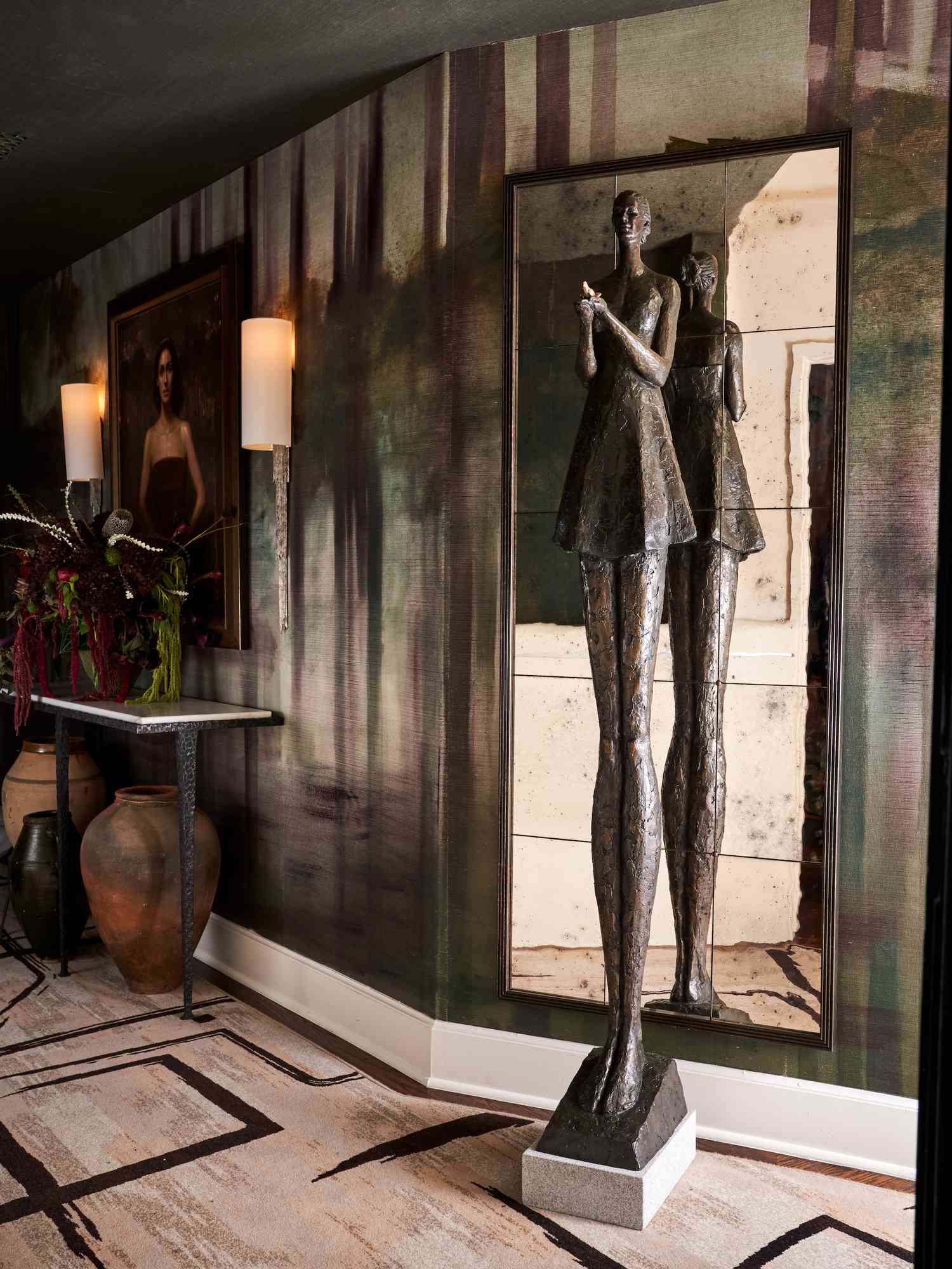 dark hallway with bold sculpture and mirror